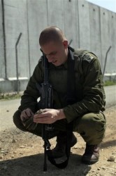An IDF soldier examines the remains of a 'rocket' fired by...someone