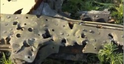 A piece of the MH17 fuselage pockmarked with holes